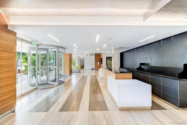 a large white kitchen with wooden floor and a fireplace