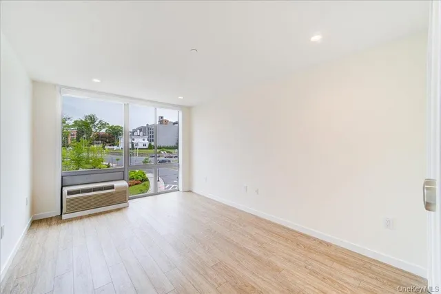 a big room with wooden floor and plants