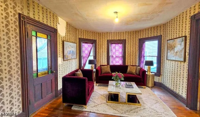 a living room with furniture and large windows