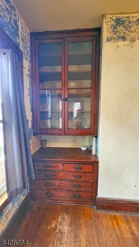 a view of a door and wooden floor