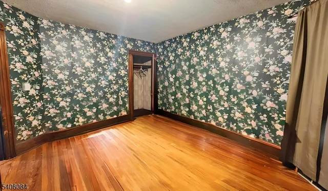 a view of entryway with window and wooden floor