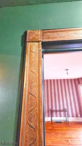 a view of a bedroom with wooden floor and closet