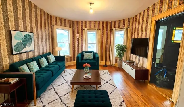 a living room with furniture fireplace and a flat screen tv
