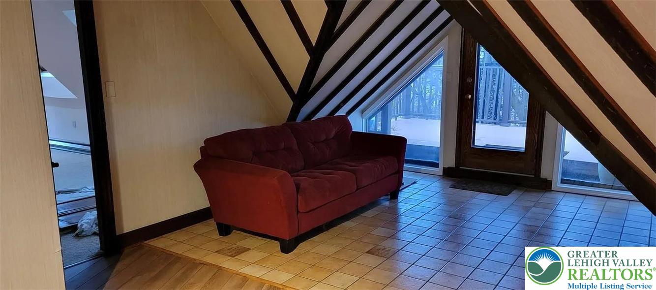 444 West 3rd Street, Unit 9 Bethlehem, PA 18015 - Photo 11 of 16 Natural light floods this unique loft space, featuring exposed beams and inviting outdoor access.