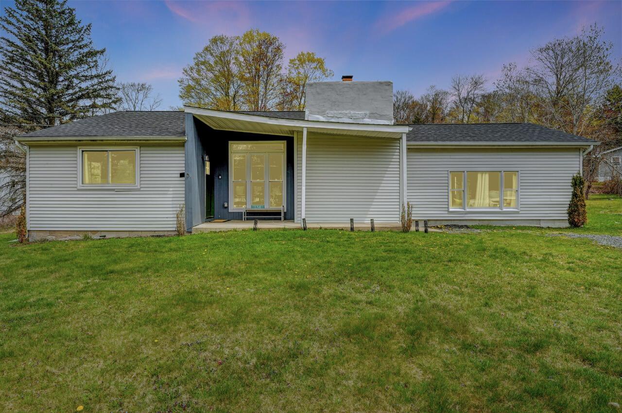 a view of a house with a yard and a garden