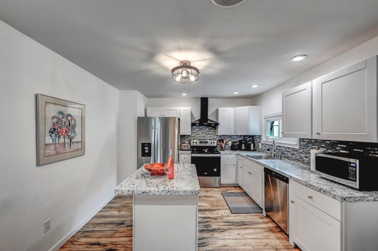 134 Altemose Road Pocono Lake, PA 18347 - Photo 17 of 48 a kitchen with stainless steel appliances kitchen island granite countertop a stove top oven a sink a refrigerator and dishwasher