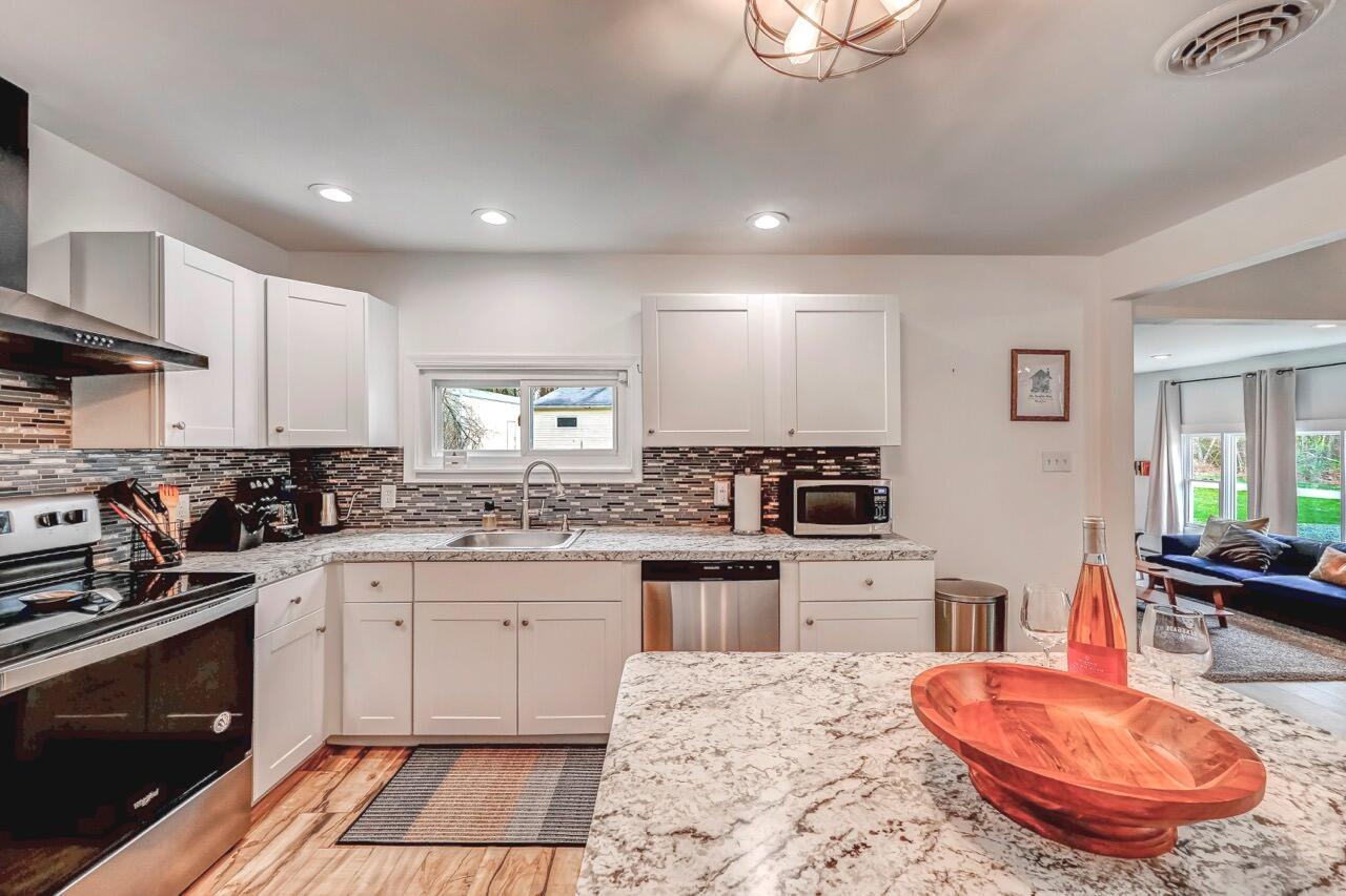 134 Altemose Road Pocono Lake, PA 18347 - Photo 22 of 48 a kitchen with a sink stove and wooden cabinets