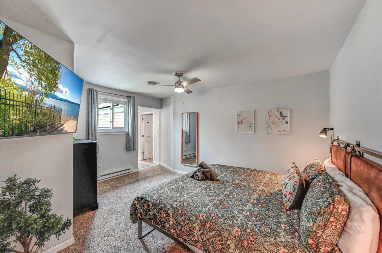 134 Altemose Road Pocono Lake, PA 18347 - Photo 25 of 48 a bedroom with a bed and a chandelier