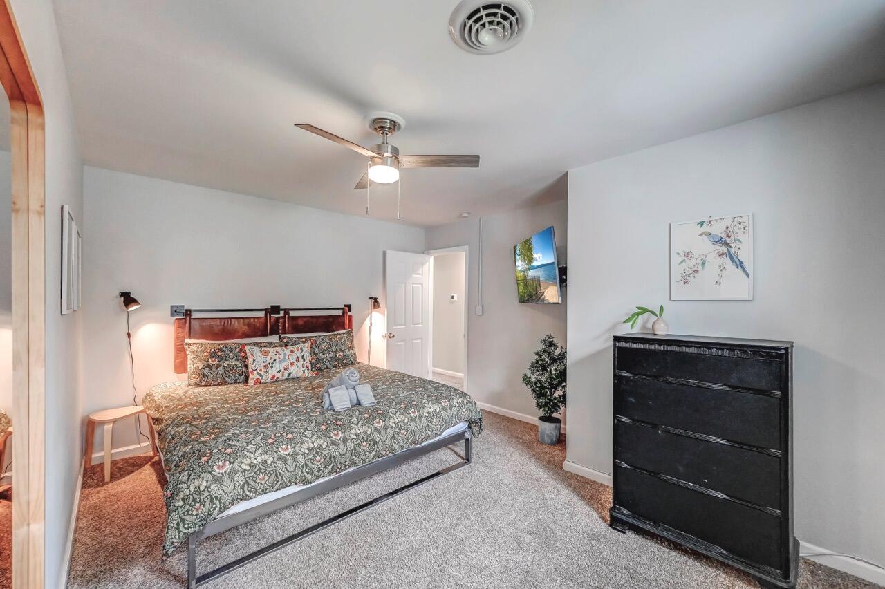 134 Altemose Road Pocono Lake, PA 18347 - Photo 27 of 48 a bedroom with a large bed and a chandelier