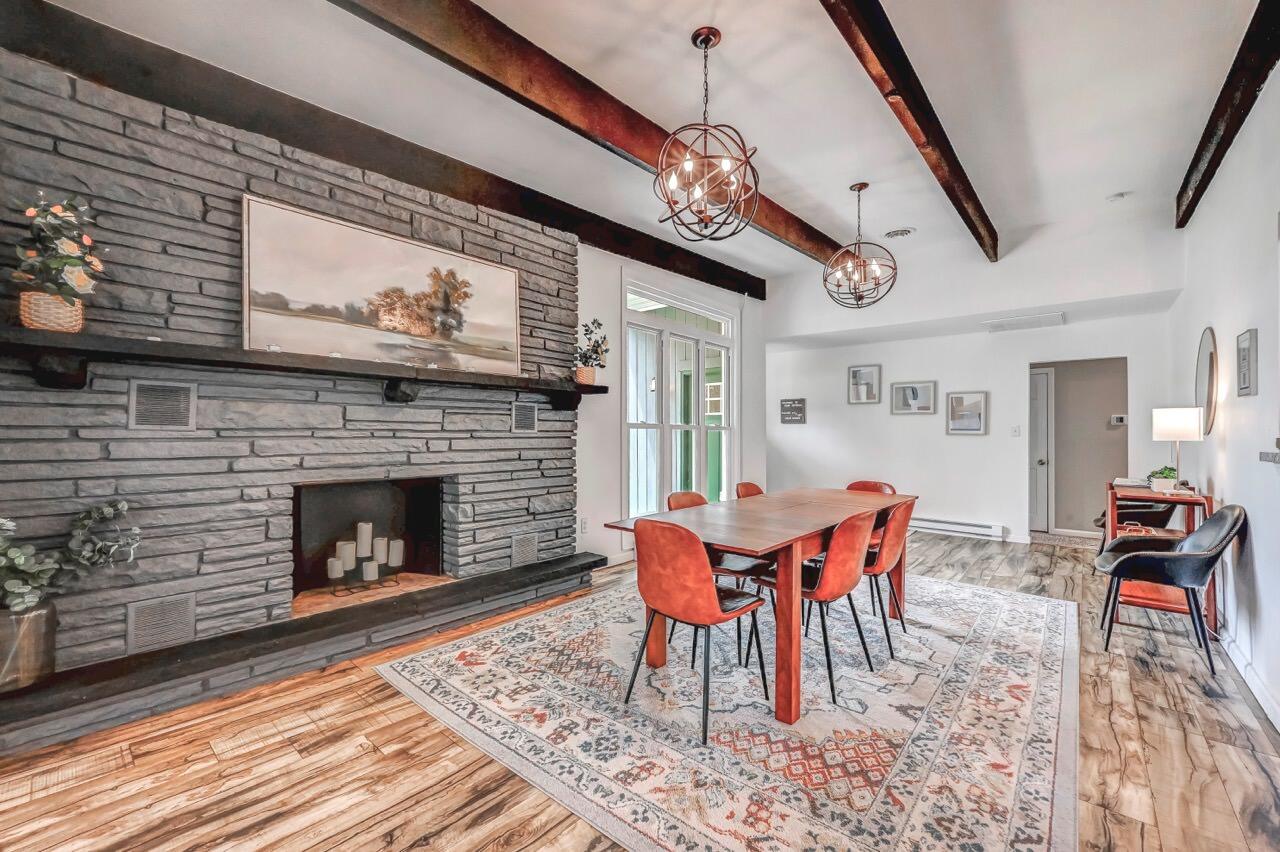 134 Altemose Road Pocono Lake, PA 18347 - Photo 6 of 48 a dining room with furniture a fireplace and wooden floor