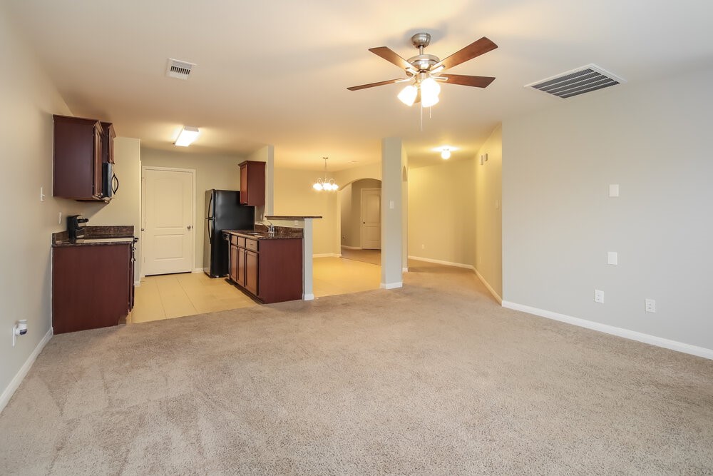 2131 Golden Topaz Drive Rosharon, TX 77583 - Photo 4 of 16 a view of a kitchen with a sink and a stove