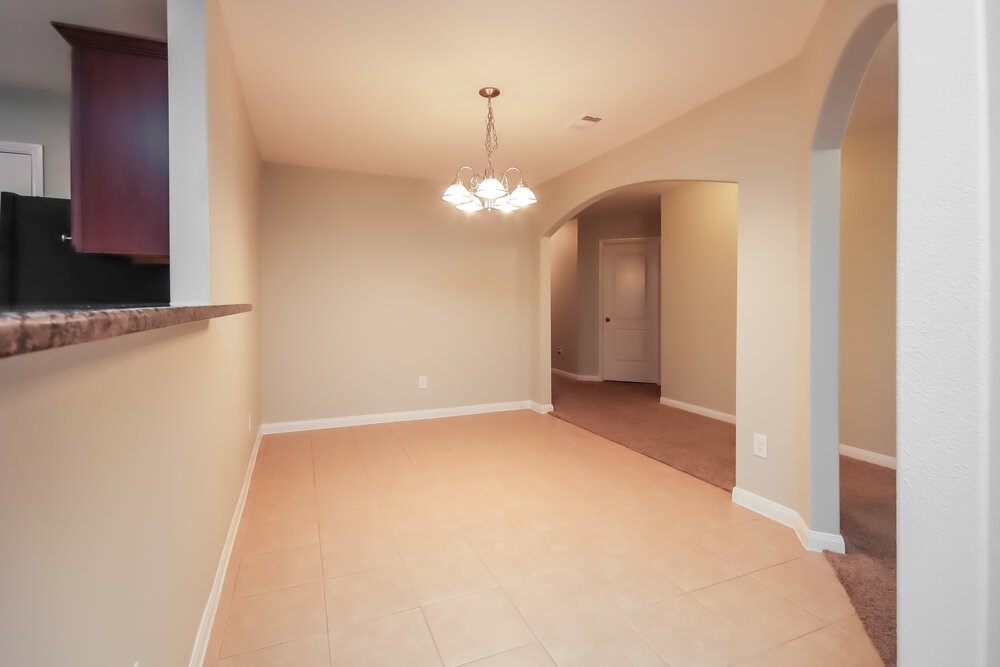 2131 Golden Topaz Drive Rosharon, TX 77583 - Photo 7 of 16 a view of a chandelier in big room with a mirror