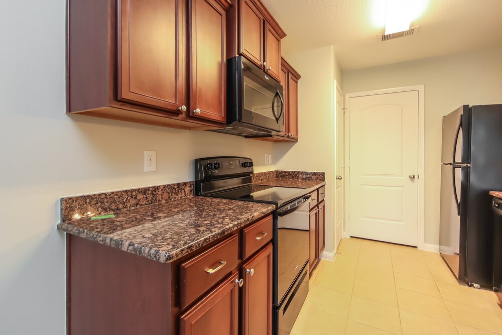 2131 Golden Topaz Drive Rosharon, TX 77583 - Photo 9 of 16 a kitchen with stainless steel appliances granite countertop a stove and a refrigerator
