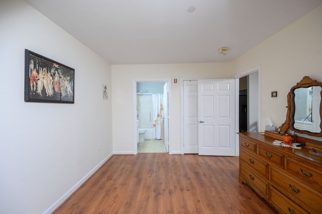 7 Assinippi Avenue, Unit 213 Norwell, MA 02061 - Photo 14 of 26 a view of room with wooden floor and cabinet
