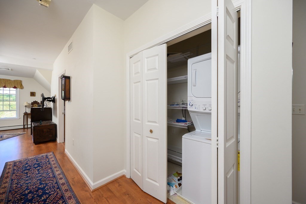7 Assinippi Avenue, Unit 213 Norwell, MA 02061 - Photo 17 of 26 a walk in closet with wooden floor