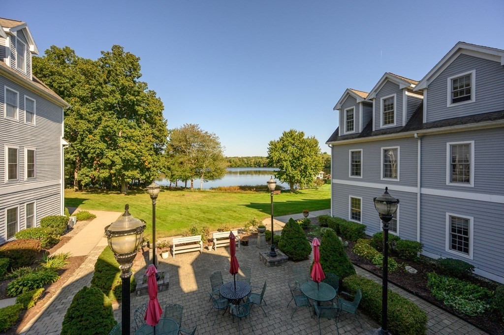 7 Assinippi Avenue, Unit 213 Norwell, MA 02061 - Photo 18 of 26 a view of a lake with couches chairs and a table
