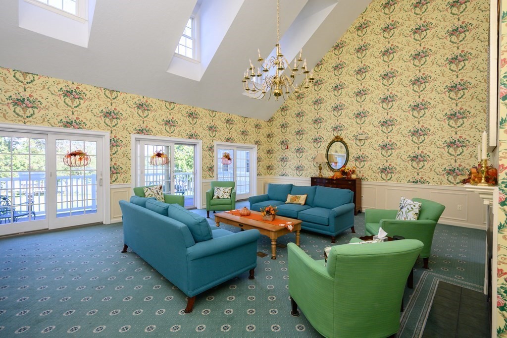7 Assinippi Avenue, Unit 213 Norwell, MA 02061 - Photo 22 of 26 a living room with furniture and a chandelier