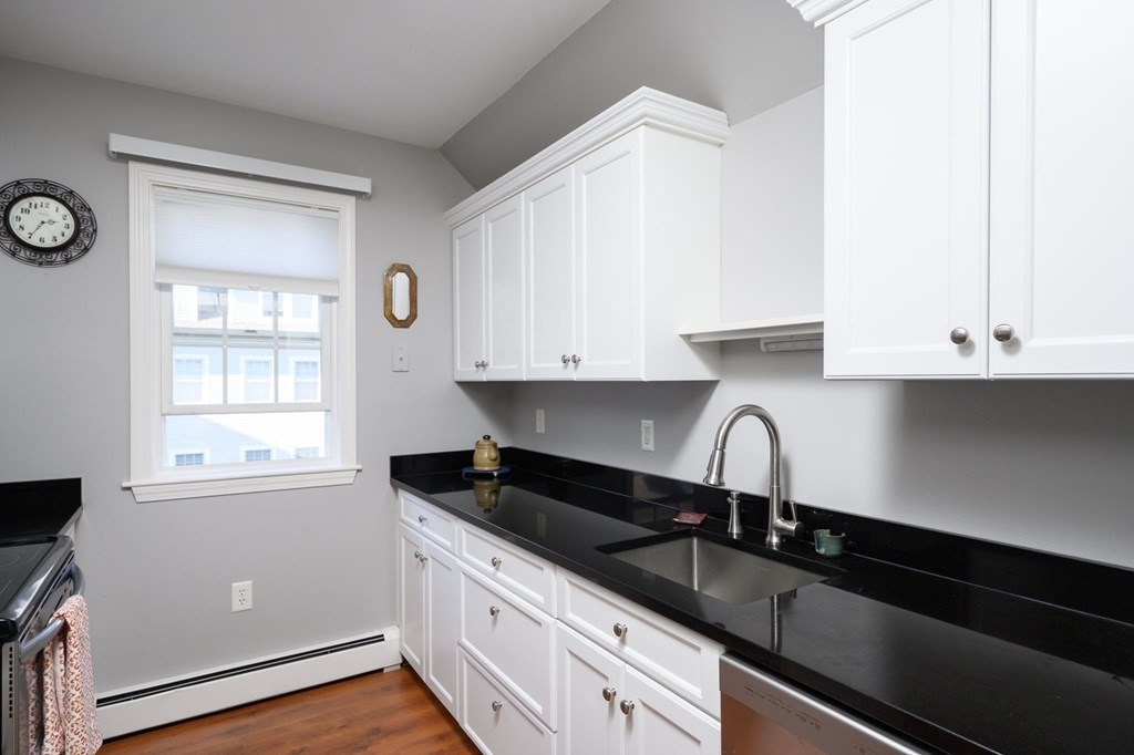 7 Assinippi Avenue, Unit 213 Norwell, MA 02061 - Photo 3 of 26 a kitchen with granite countertop white cabinets and a sink