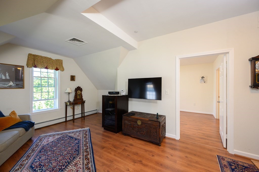 7 Assinippi Avenue, Unit 213 Norwell, MA 02061 - Photo 6 of 26 a living room with furniture and a flat screen tv