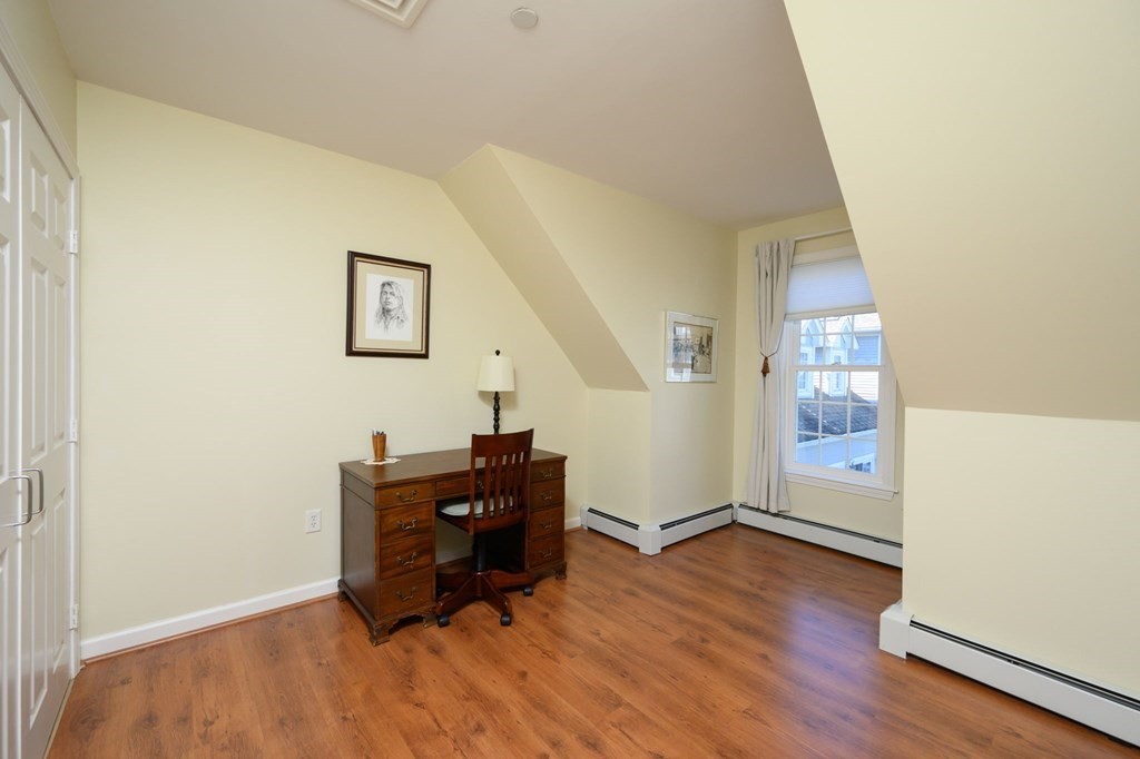 7 Assinippi Avenue, Unit 213 Norwell, MA 02061 - Photo 10 of 26 an empty room with wooden floor and windows