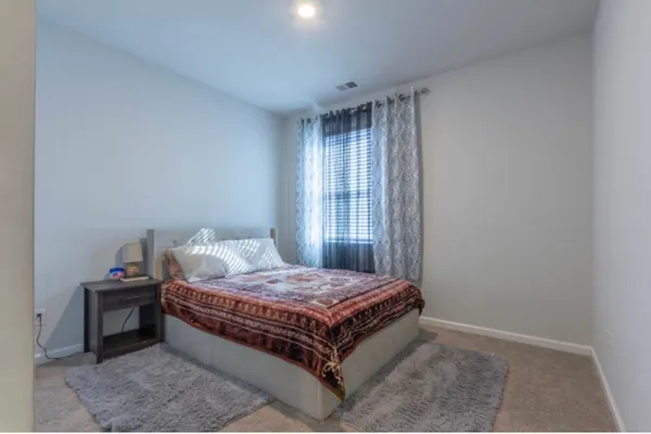 a bedroom with a bed and a window