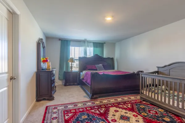 a bedroom with bed and a window