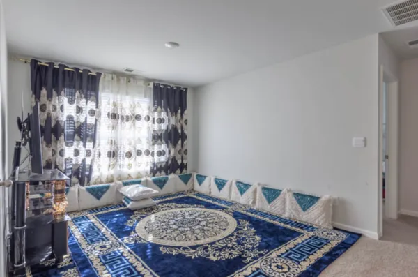a living room with furniture and a rug