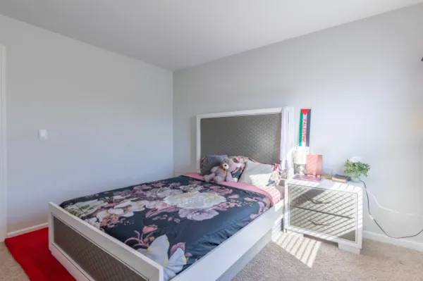 a bedroom with a bed and a dresser