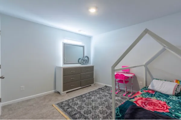 a bedroom with a bed and a dresser