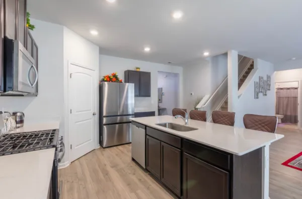 a kitchen with refrigerator and cabinets