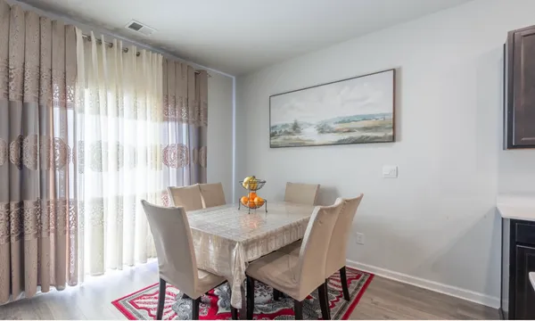 a dining room with furniture and window