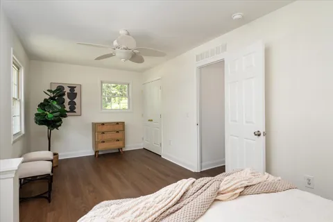 a bedroom with a bed and a potted plant