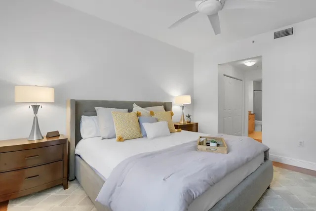 a bedroom with a bed and a lamp