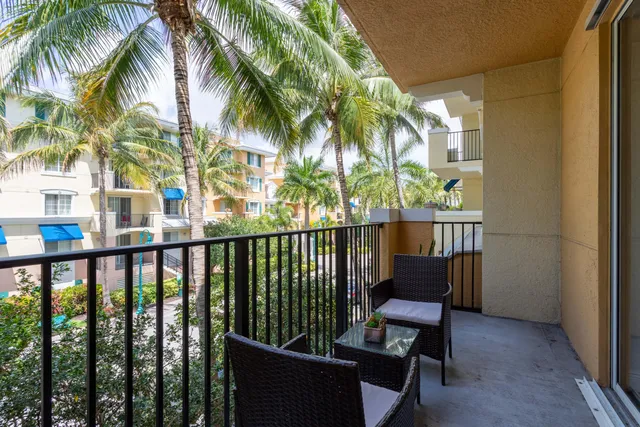 a view of a balcony with outdoor seating