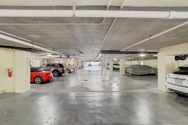 a view of parking garage with cars parked