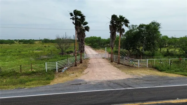 a view of a yard with wooden fence