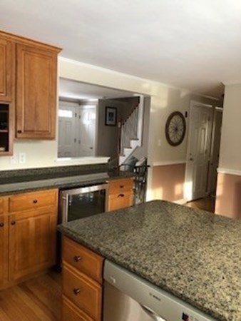 138 Highgate Street Needham, MA 02492 - Photo 3 of 17 a kitchen with kitchen island a counter top and a stove