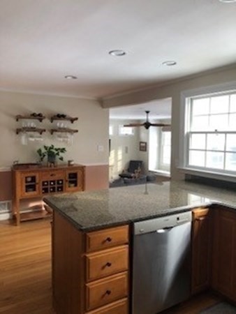 138 Highgate Street Needham, MA 02492 - Photo 4 of 17 a kitchen with stainless steel appliances granite countertop a sink a stove and a wooden cabinets