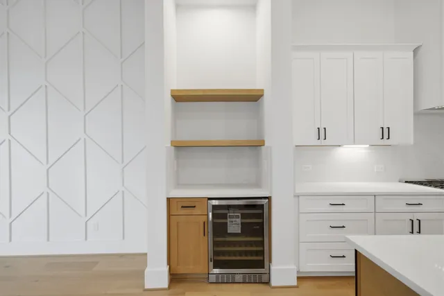 a kitchen with white cabinets and white appliances