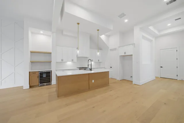 a large kitchen with stainless steel appliances granite countertop a stove and a sink
