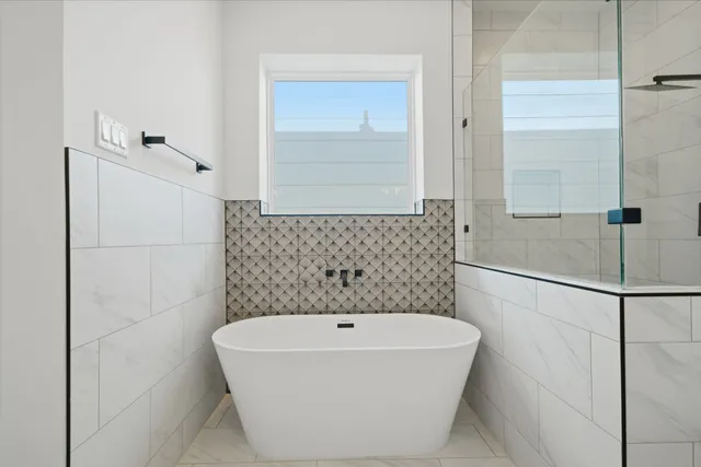 a bathroom with a bathtub and shower