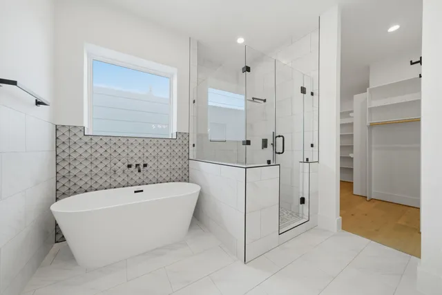 a bathroom with a bathtub and shower