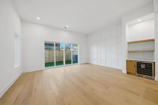 a view of an empty room with a fireplace and a window