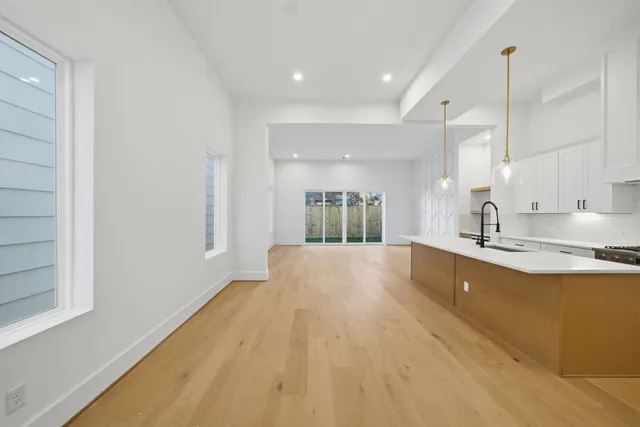 a large kitchen with kitchen island a sink stainless steel appliances and cabinets