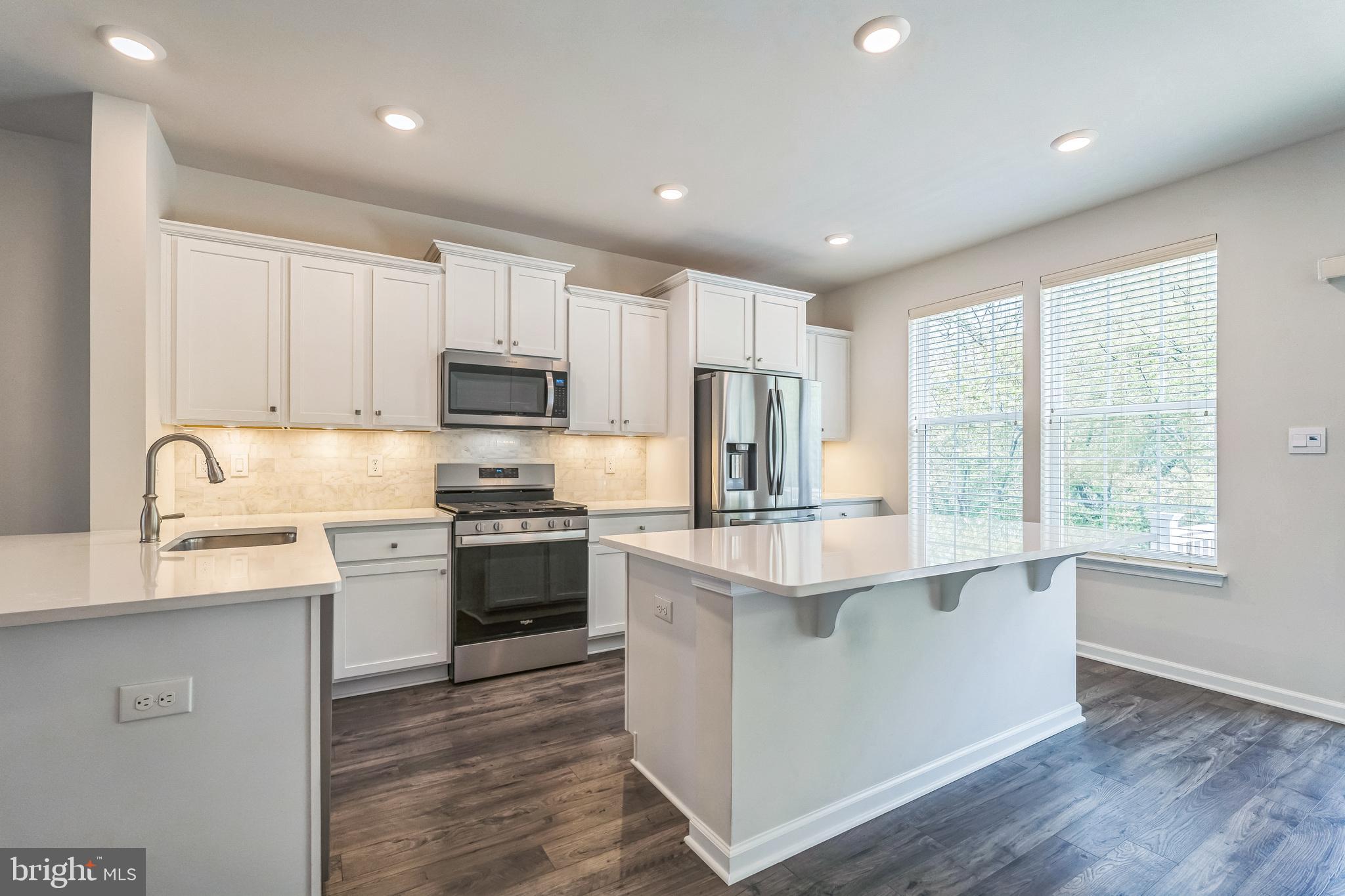 11 Lilac Circle Mount Laurel, NJ 08054 - Photo 3 of 43 a kitchen with kitchen island granite countertop white cabinets and stainless steel appliances