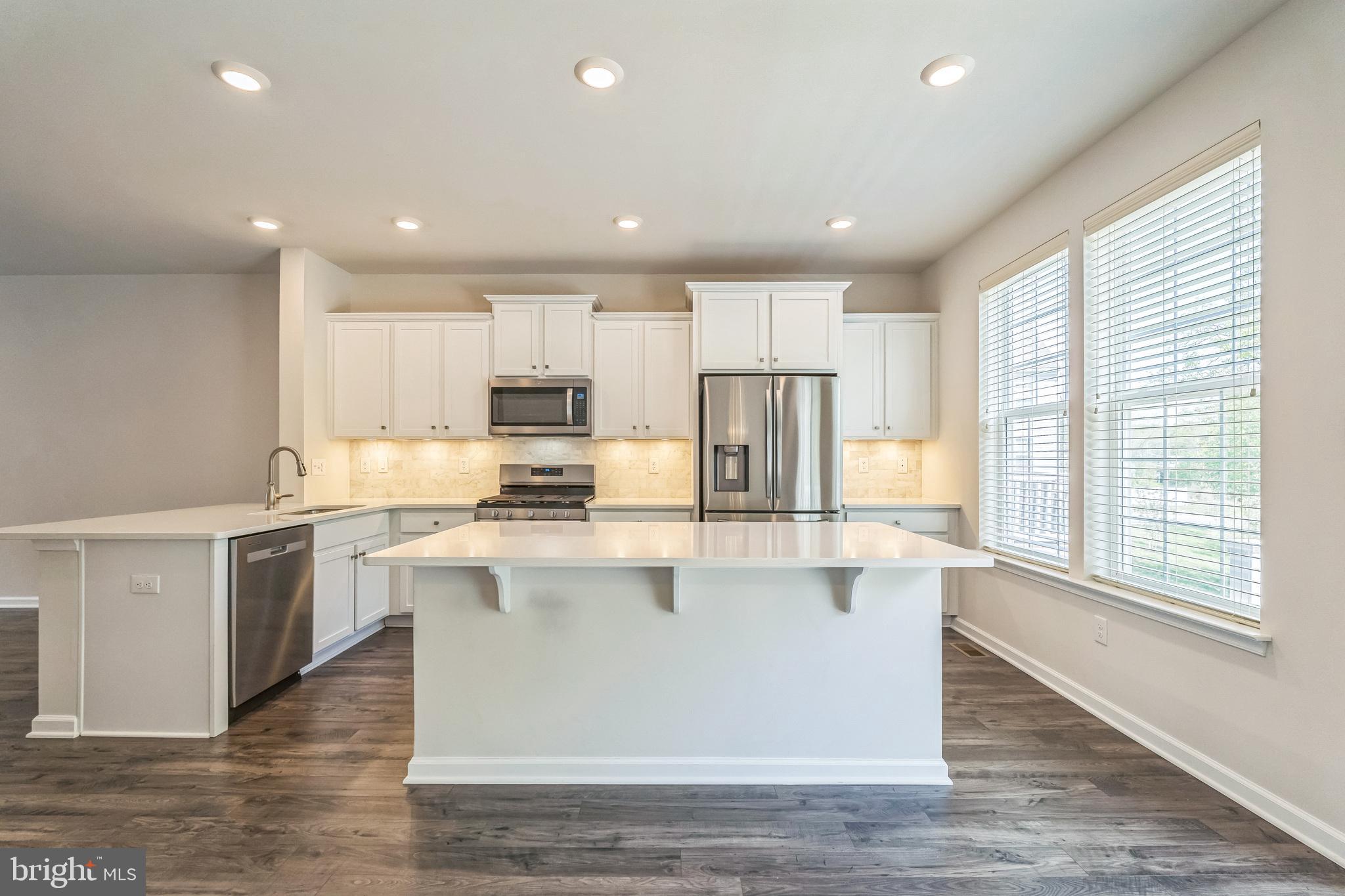 11 Lilac Circle Mount Laurel, NJ 08054 - Photo 8 of 43 a kitchen with stainless steel appliances granite countertop a refrigerator a stove top oven a sink and dishwasher with wooden floor