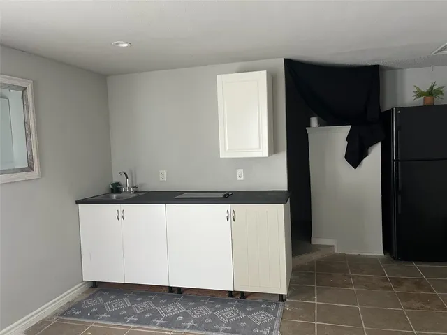 a view of cabinets with refrigerator