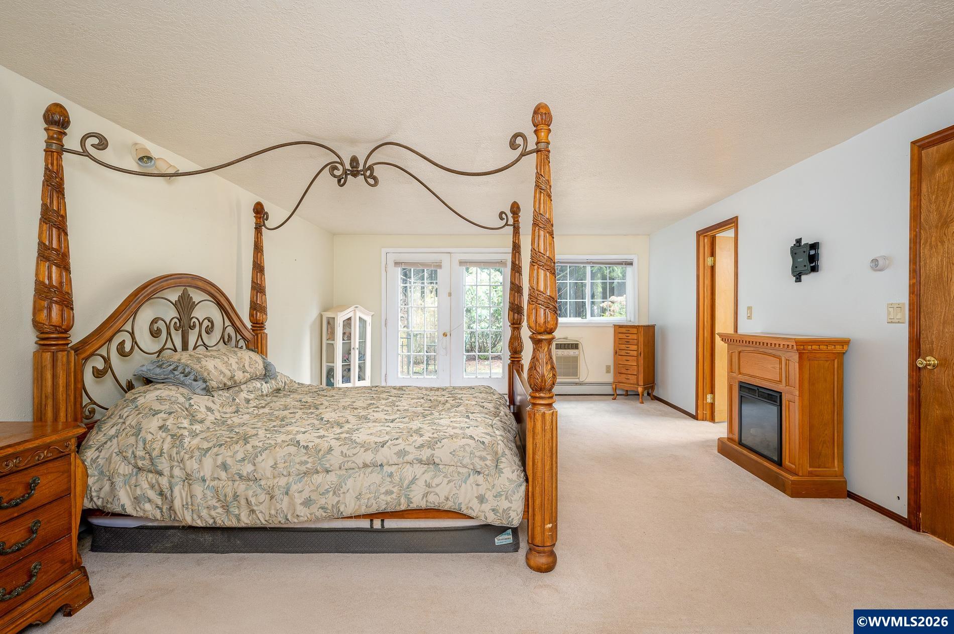 27572 South Kinzy Road Estacada, OR 97023 - Photo 40 of 50 a bedroom with a bed next to a window with fireplace