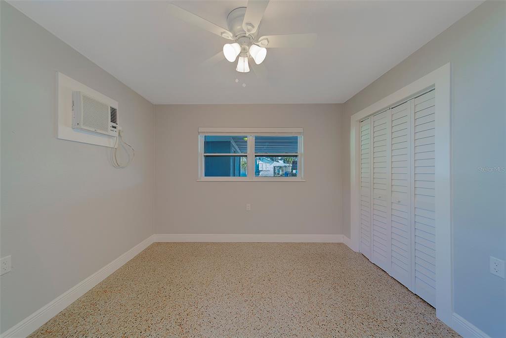 13248 4th Street East, Unit A Madeira Beach, FL 33708 - Photo 14 of 54 a view of a livingroom with a ceiling fan and window