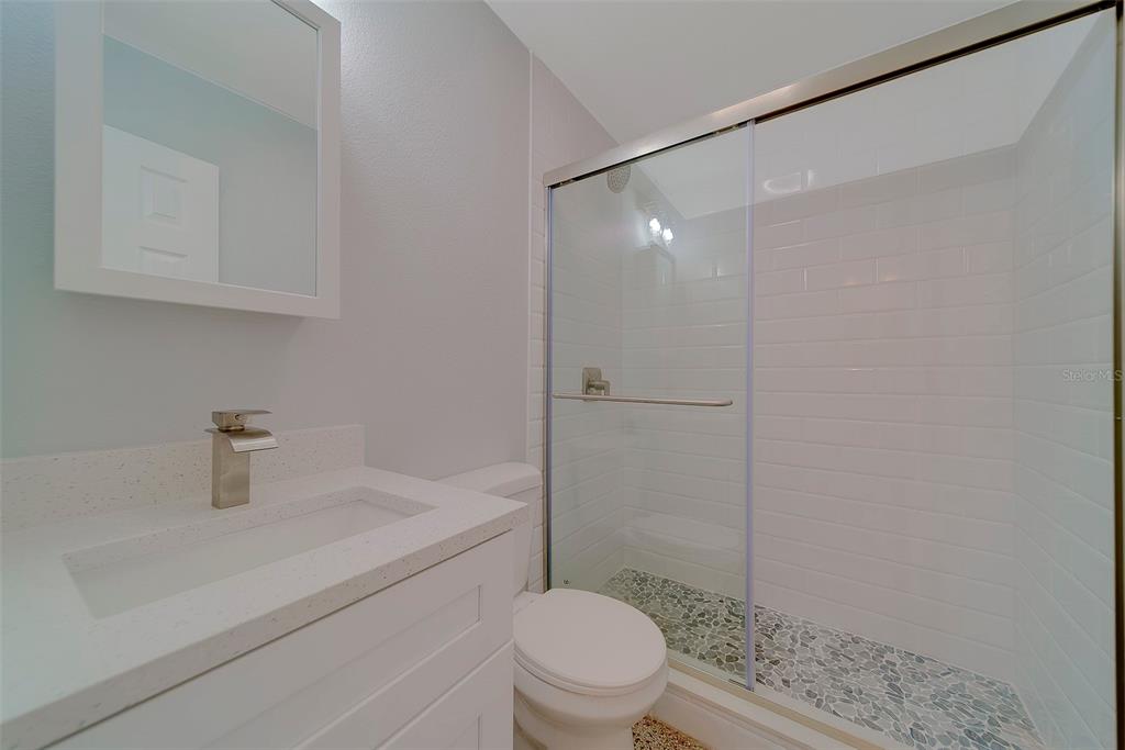 13248 4th Street East, Unit A Madeira Beach, FL 33708 - Photo 16 of 54 a bathroom with a sink a toilet and shower